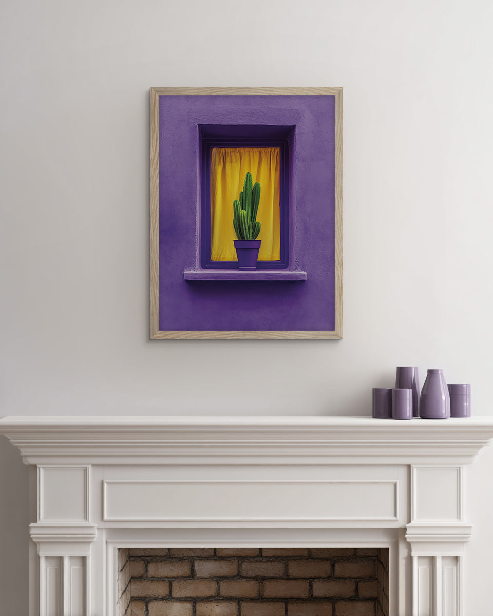 Wall art of a green Cactus in a pot in front of a yellow curtain on the ledge of a purple window frame on a purple wall